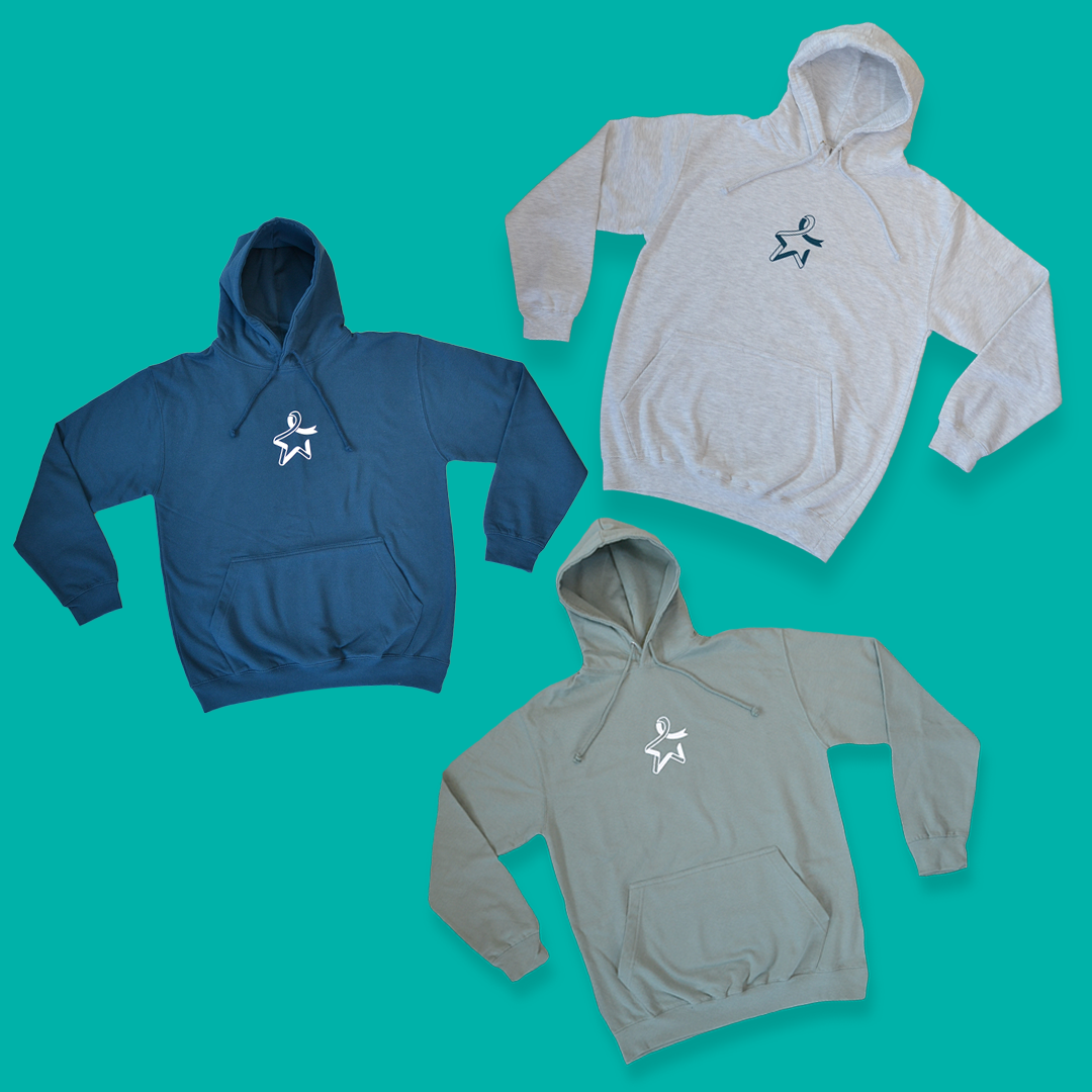Three hoodies with front pockets and drawstrings displayed against a light teal background. Top left: blue hoodie with a white Star of Hope on the front. Top right: grey hoodie with a dark teal Star of Hope on the front. Bottom right: green hoodie with a white Star of Hope on the front.
