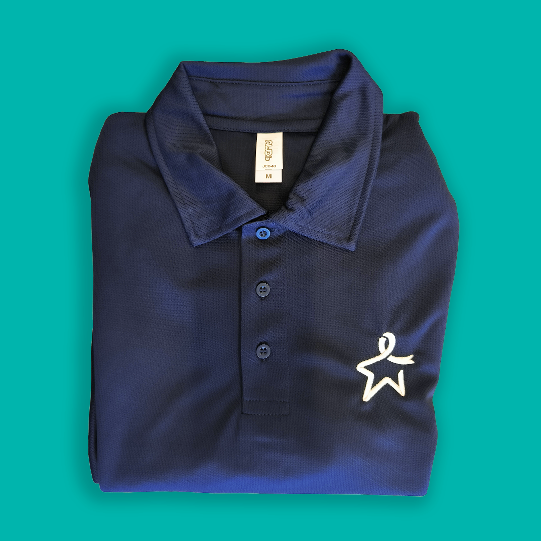 Flat lay of a folded French navy polo shirt featuring a white Star of Hope emblem on the left chest.