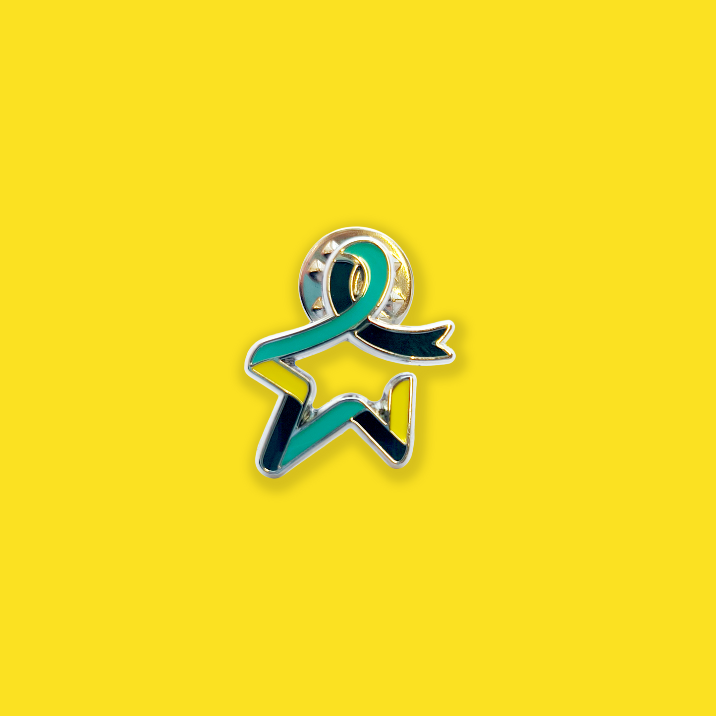 Our Star of Hope pin badge with a dark teal, light teal, and yellow multicoloured Star of Hope design, shown against a yellow background.