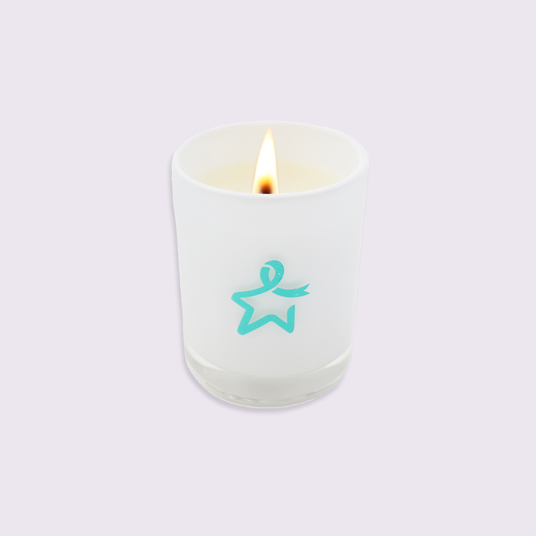 Lit white glass candle featuring a teal Star of Hope design on a white background.