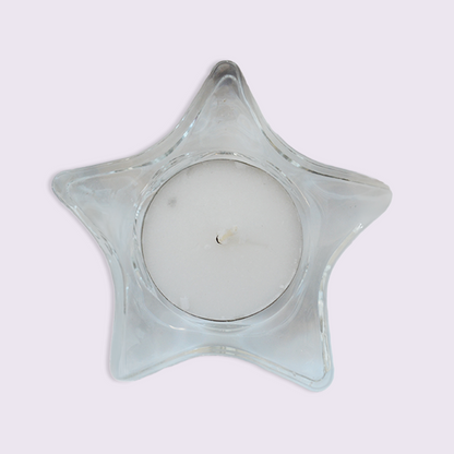 Star-shaped glass candle holder on a white background