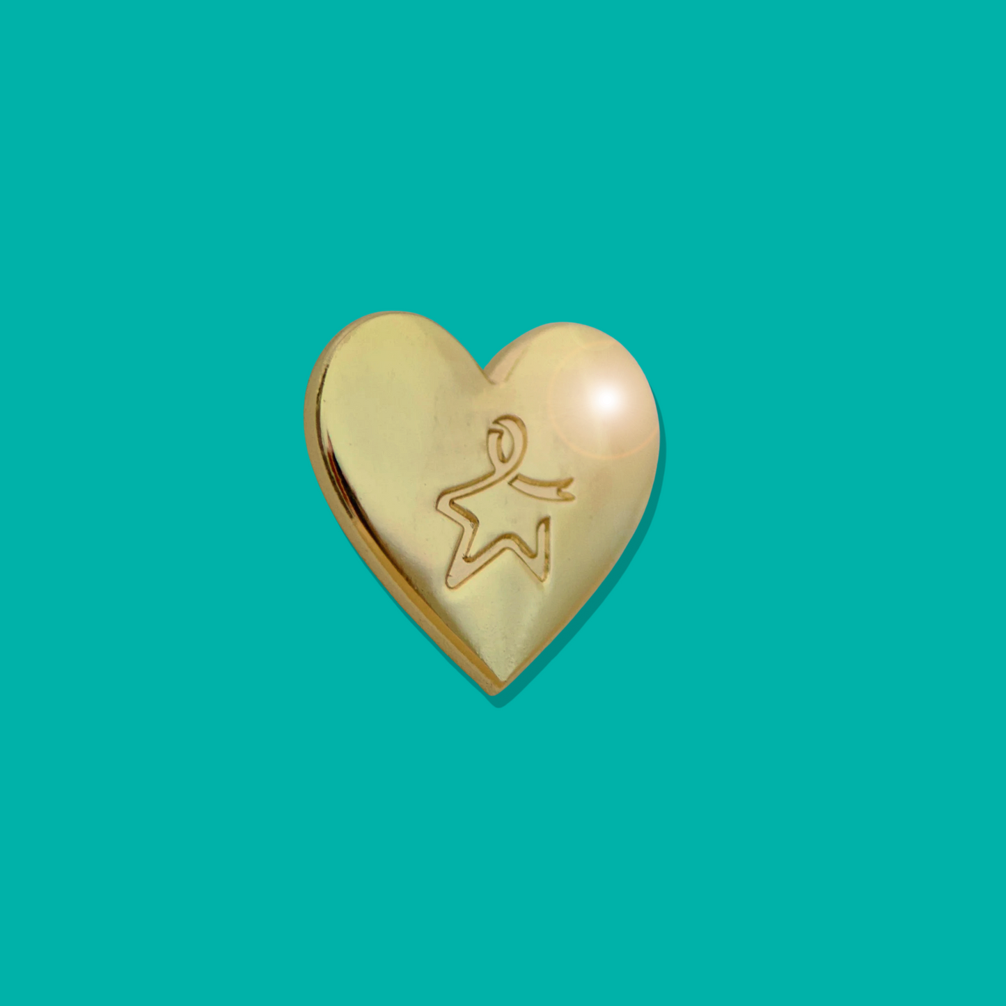 Gold heart‑shaped pin badge with an engraved Star of Hope, shown against a light teal background.