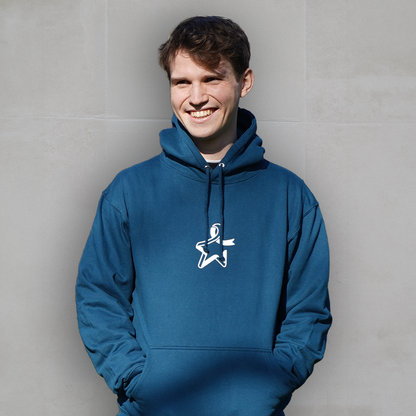 Male model wearing a blue hoodie, standing against a grey background. The hoodie features a white Star of Hope printed on the front.